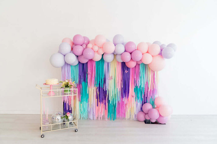 Oh My Darling Party Co purple, blue, and peach fringe butterfly backdrop and balloon garland