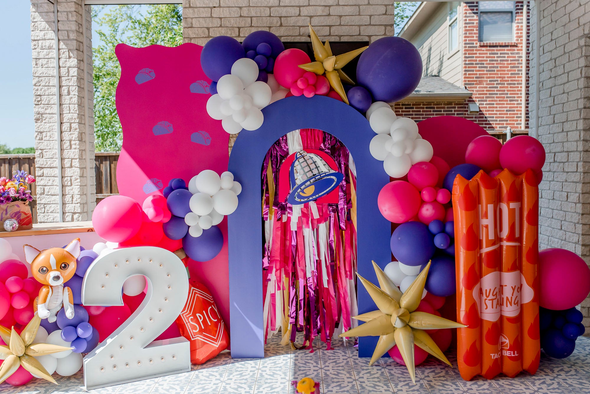 Taco Bell themed fringe backdrop and balloon party installation by Oh My Darling Party Co