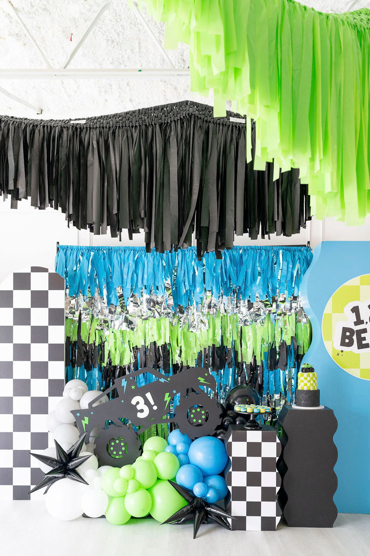 Car/Truck themed boy's party fringe backdrop and aerial garlands in black, blue, and green by Oh My Darling Party Co