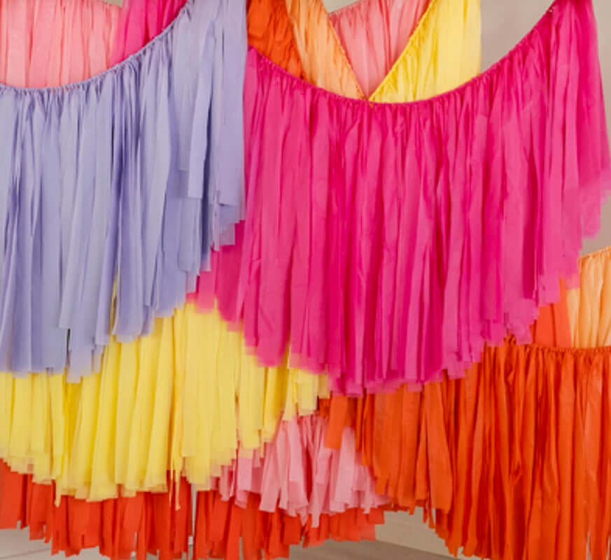 Close up photo of multicolor fringe garland strands by Oh My Darling Party Co