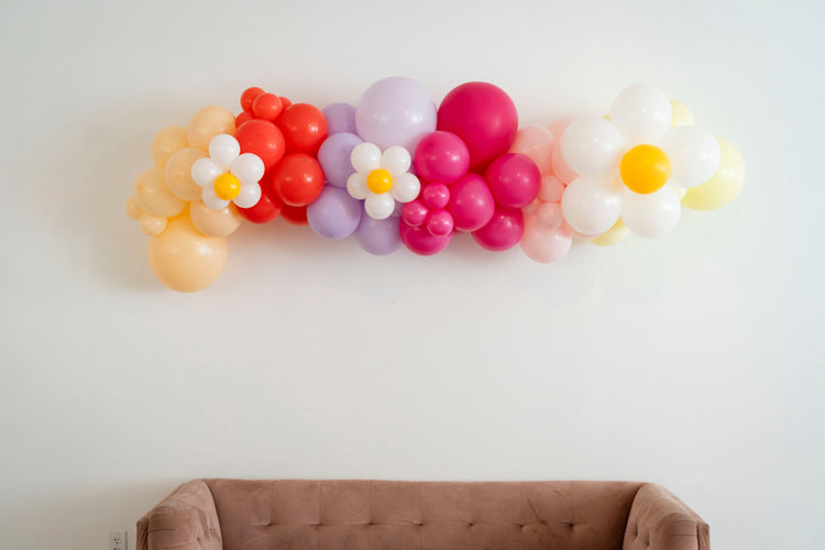 Floral pink, purple, and yellow balloon garland by Oh My Darling Party Co