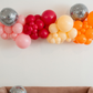 Let's Disco Balloon Kit fringe garland hanging against a white wall with balloons. Fringe decor perfect for corporate events or parties.