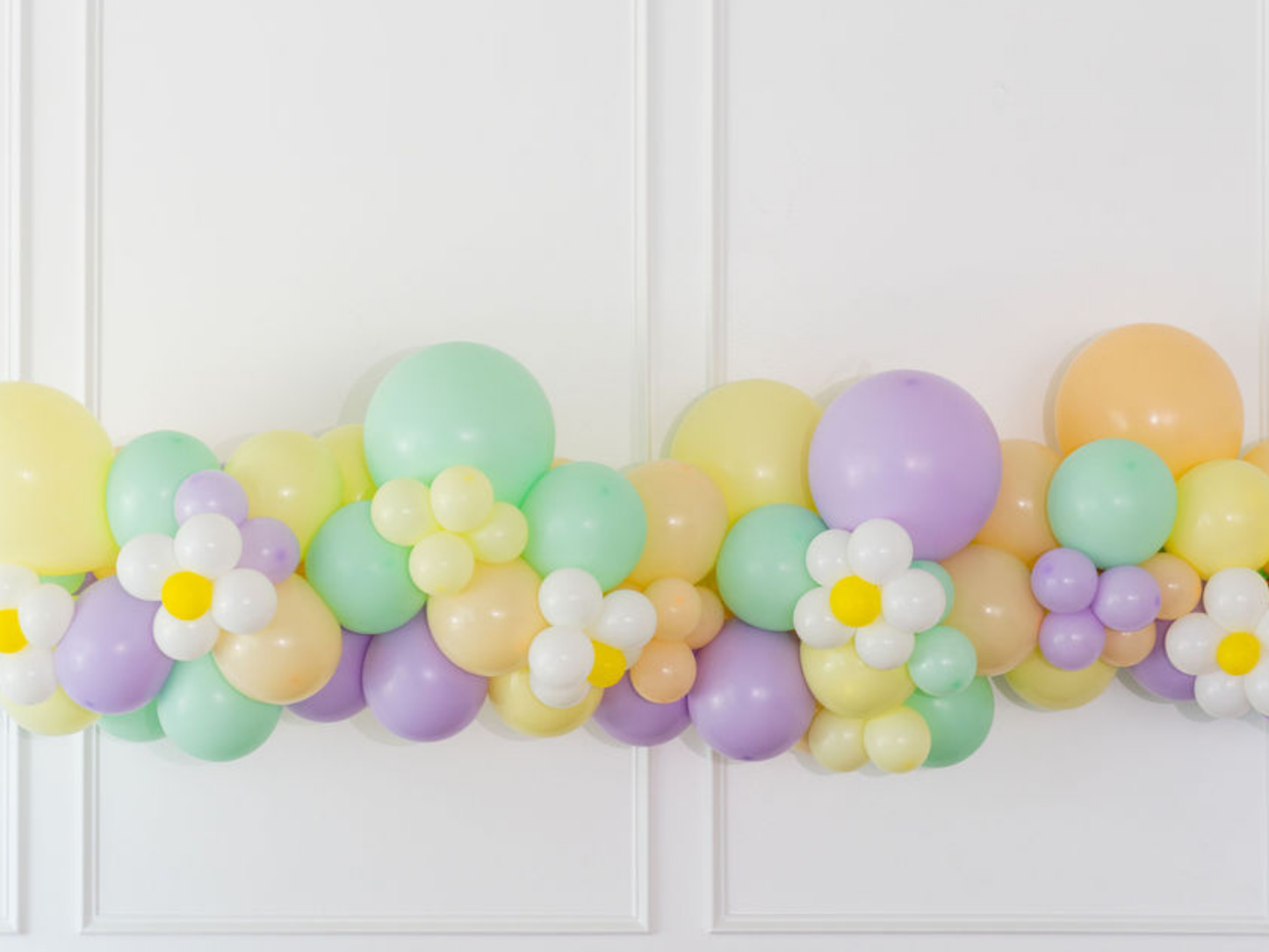 Hip Hop Balloon Kit fringe garland hanging against a white wall with balloons. Fringe decor perfect for corporate events or parties.