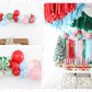 Merry & Bright Balloon Kit fringe garland hanging against a white wall with balloons. Fringe decor perfect for corporate events or parties.