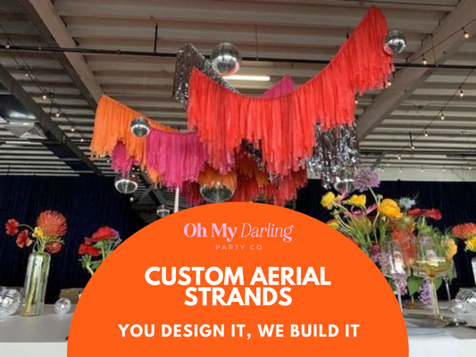 Custom Aerial Fringe - Etsy 1 fringe garland hanging against a white wall with balloons. Fringe decor perfect for corporate events or parties.