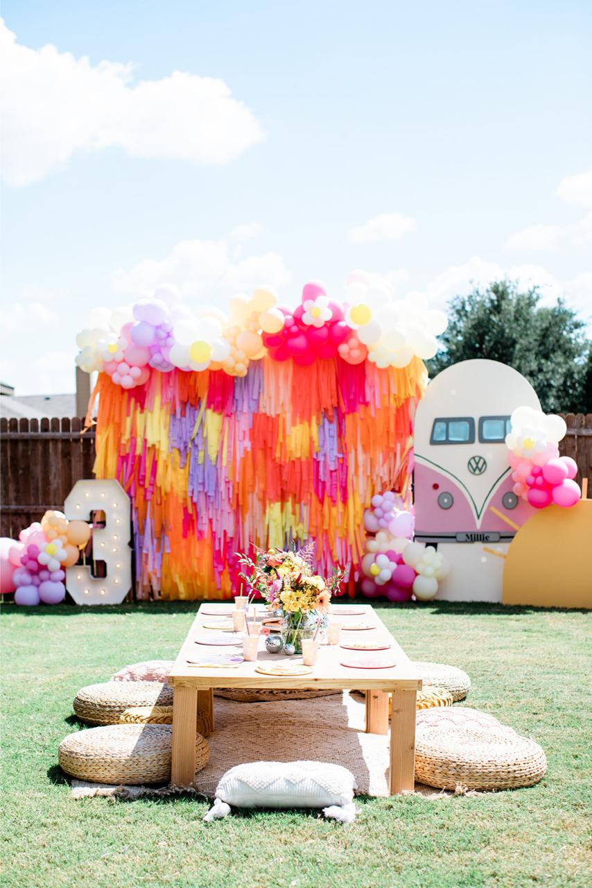 Outdoor retro party fringe backdrop installation by Oh My Darling Party Co