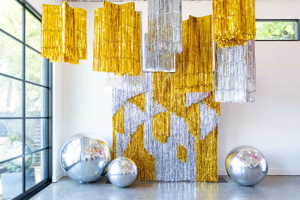 Metallic tinsel fringe star styled overhead for a kids' party