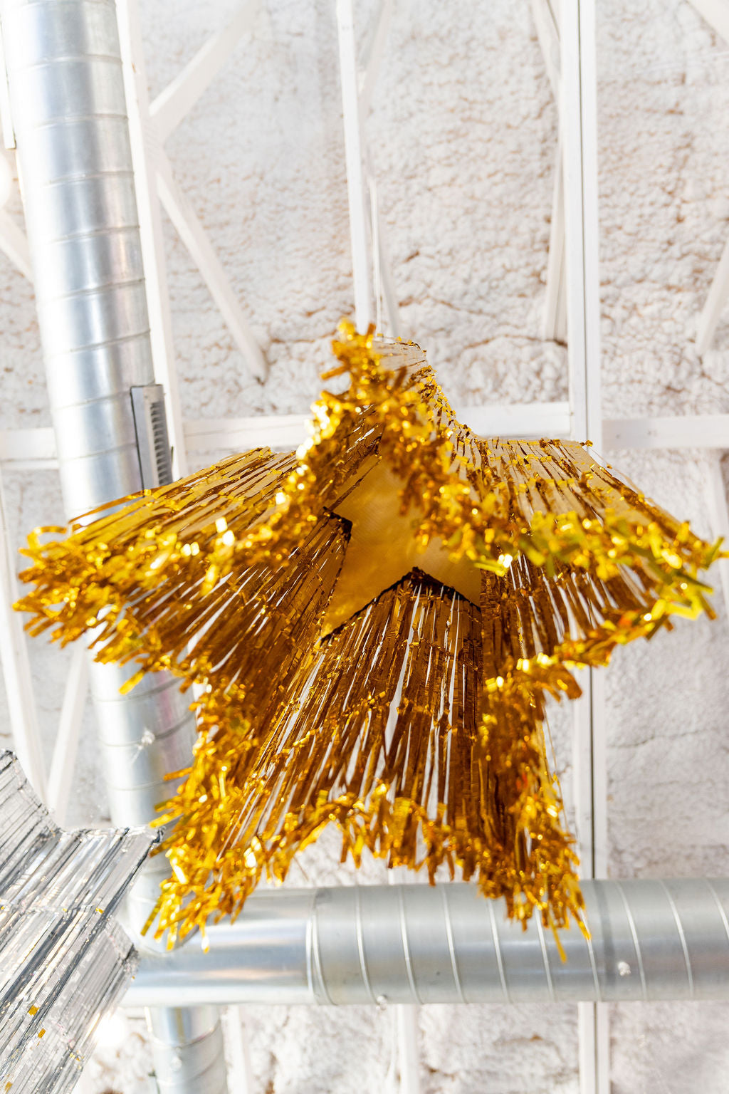 Handmade tinsel star hanging flat from the ceiling