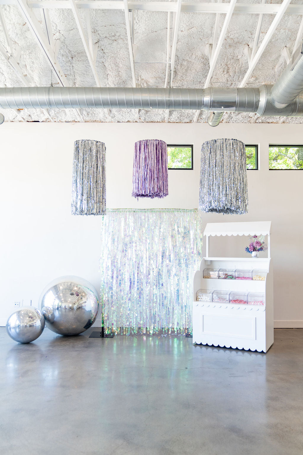 Metallic tinsel fringe aerial ring hanging from the ceiling