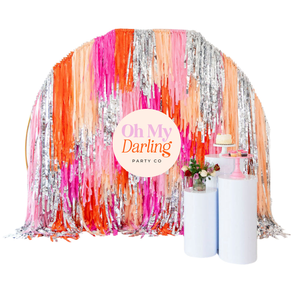 Semi circle fringe party backdrop with Oh My Darling Party Co logo badge