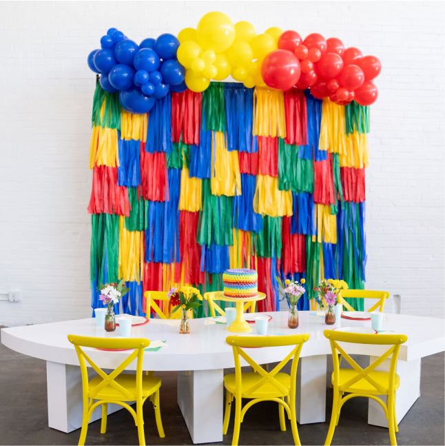 Lego style primary color fringe backdrop and balloon garland for boy's birthday party by Oh My Darling Party Co