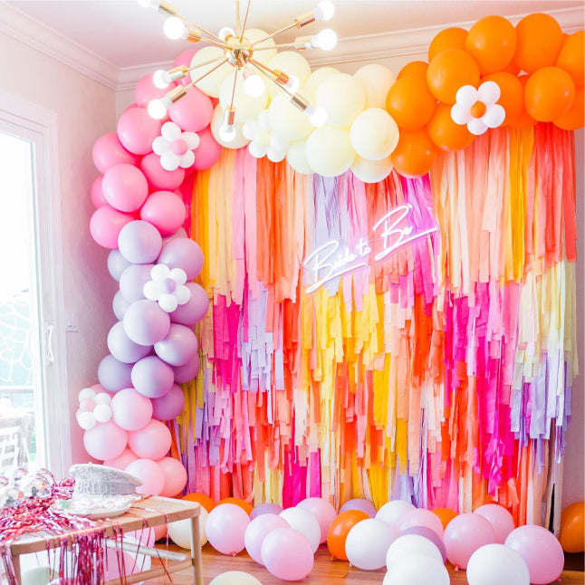 Pink, orange, and purple bachelorette themed fringe backdrop and balloon garland by Oh My Darling Party Co