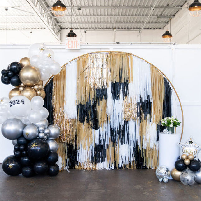 Graduation black, gold, and white arched fringe backdrop for grad party by Oh My Darling Party Co