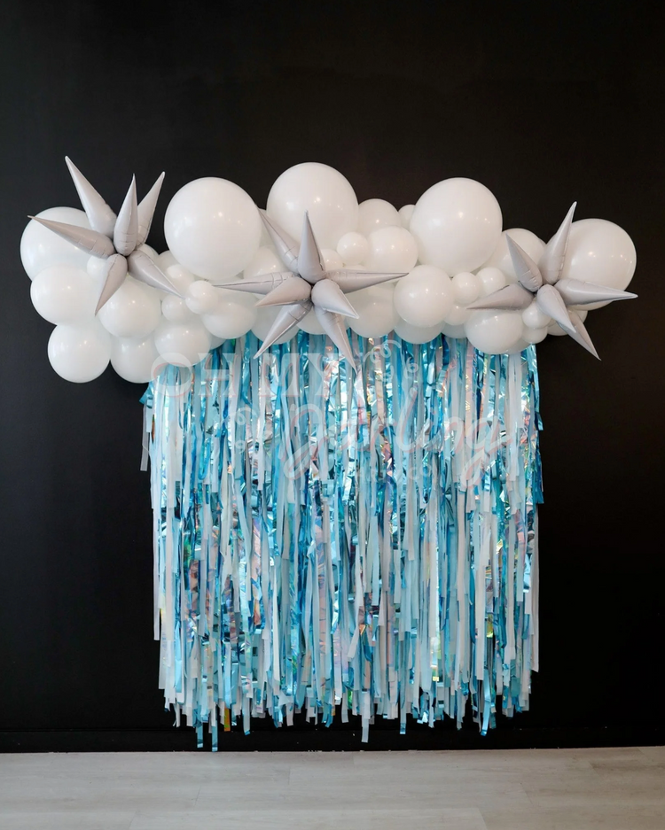 Blue, silver, and white fringe party backdrop and balloon garland by Oh My Darling Party Co 