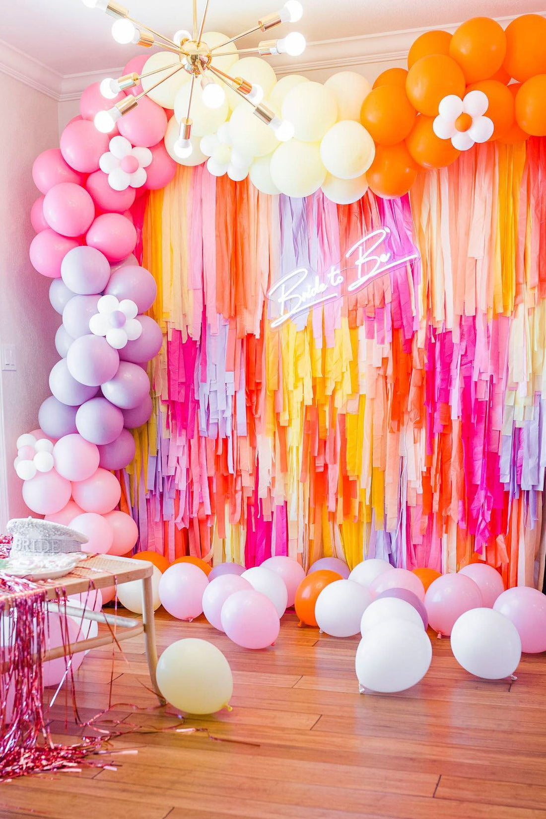 Pink, orange, and purple bachelorette themed fringe backdrop and balloon garland by Oh My Darling Party Co