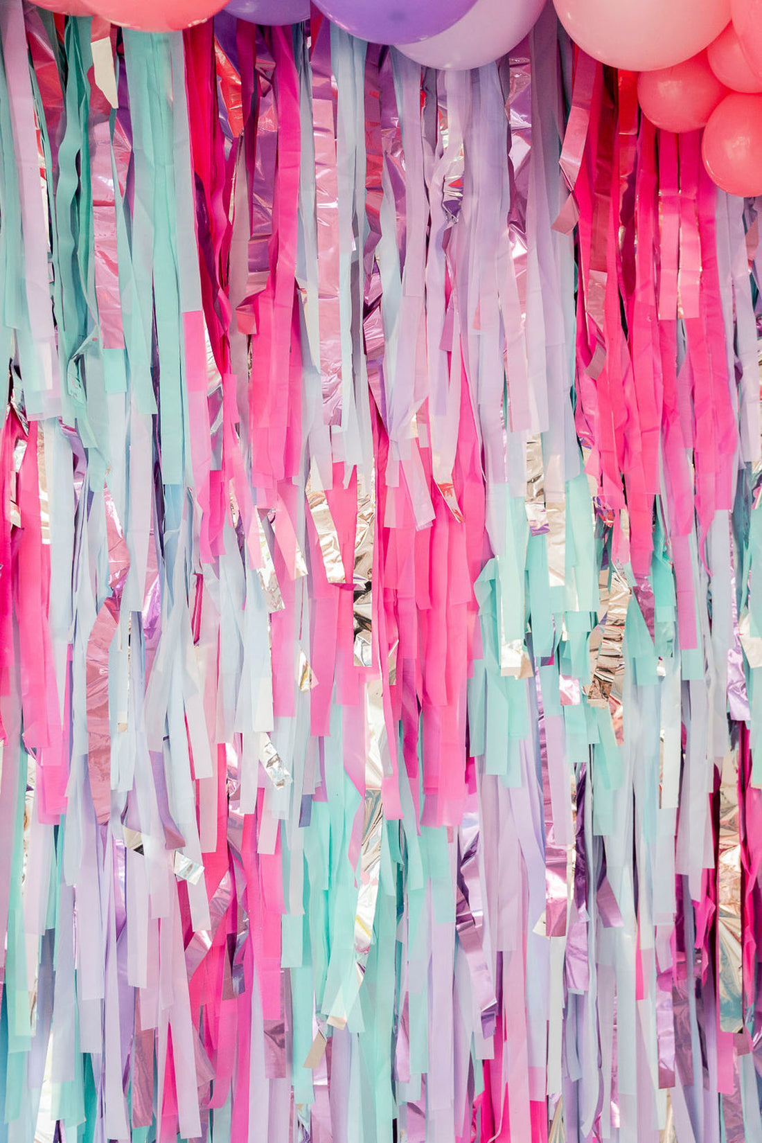 Close up of multicolor fringe backdrop by Oh My Darling Party Co